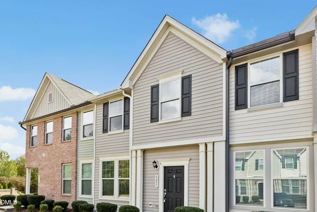 a front view of a residential apartment building with a yard