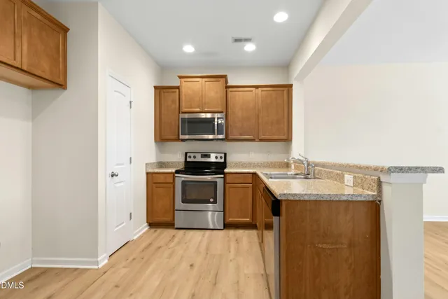 a view of a room with wooden floor and cabinet