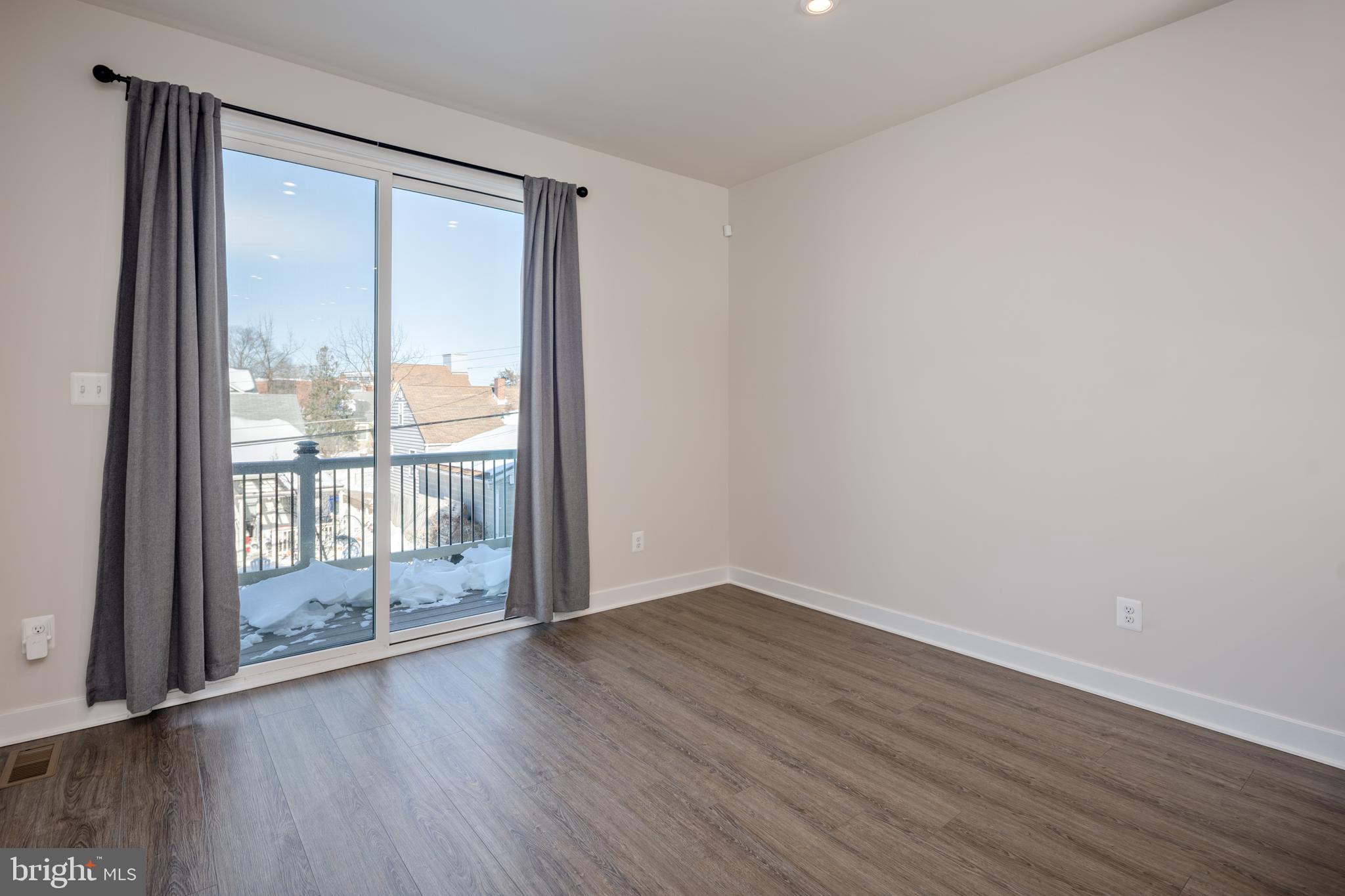 1920 Four Roses Street Baltimore, MD 21222 - Photo 11 of 37 a view of an empty room with wooden floor and a window