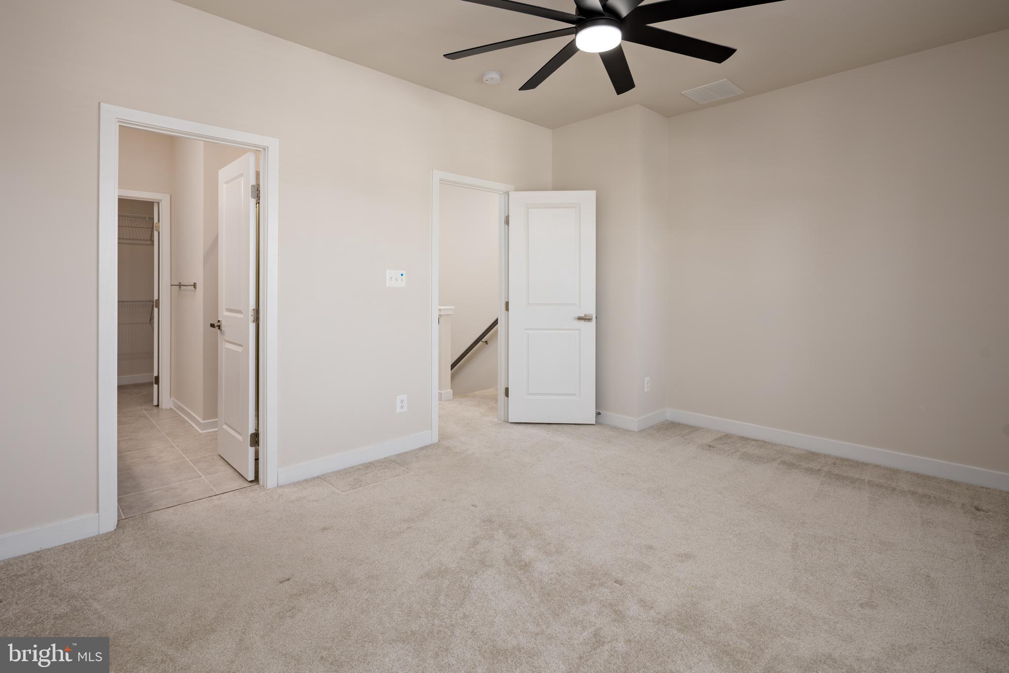 1920 Four Roses Street Baltimore, MD 21222 - Photo 15 of 37 an empty room with a ceiling fan and carpet