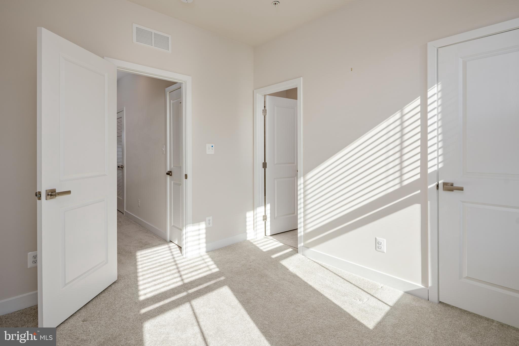 1920 Four Roses Street Baltimore, MD 21222 - Photo 23 of 37 a view of a bedroom with wooden floor and white walls