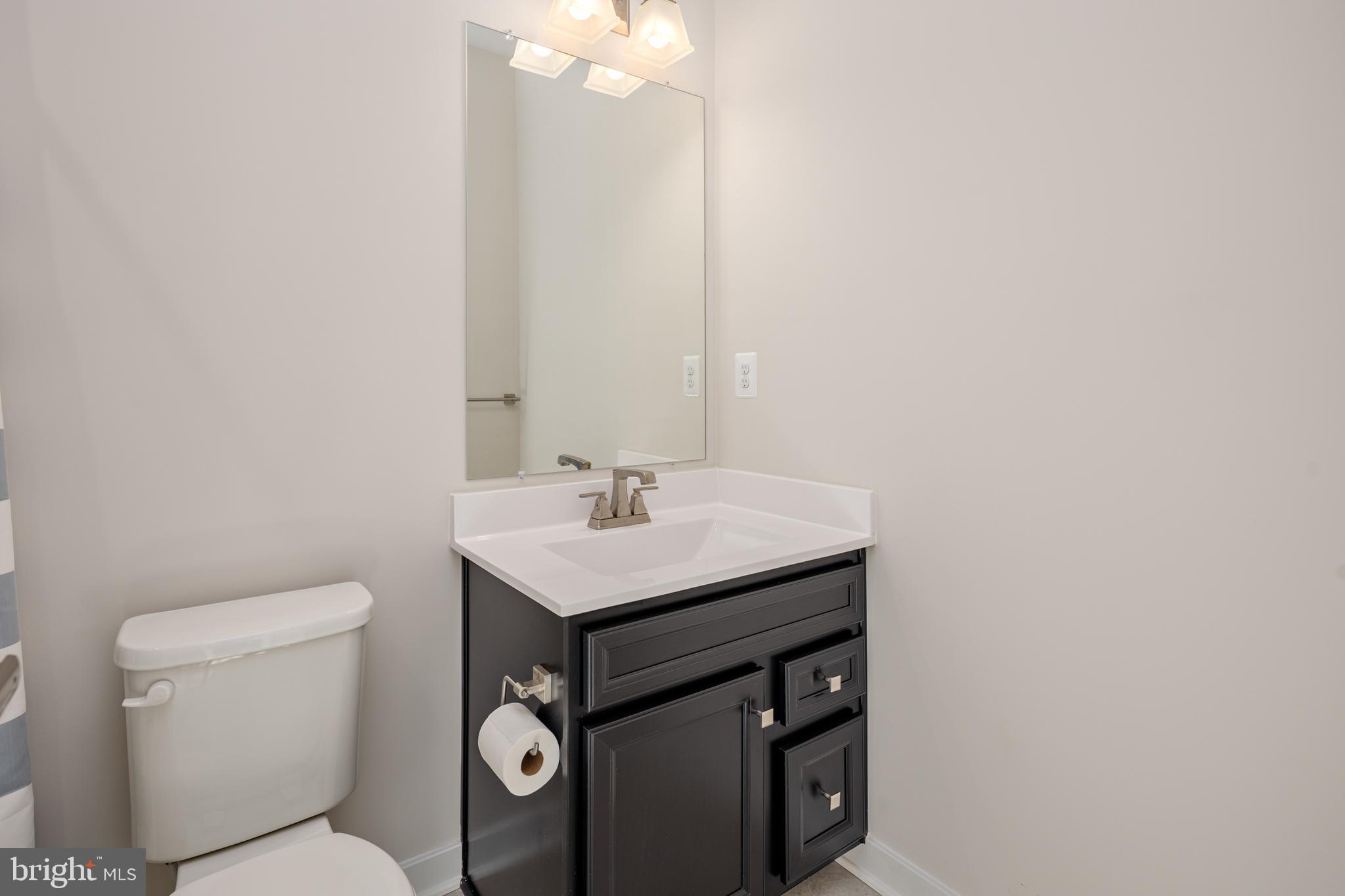 1920 Four Roses Street Baltimore, MD 21222 - Photo 27 of 37 a bathroom with a toilet a sink and a mirror
