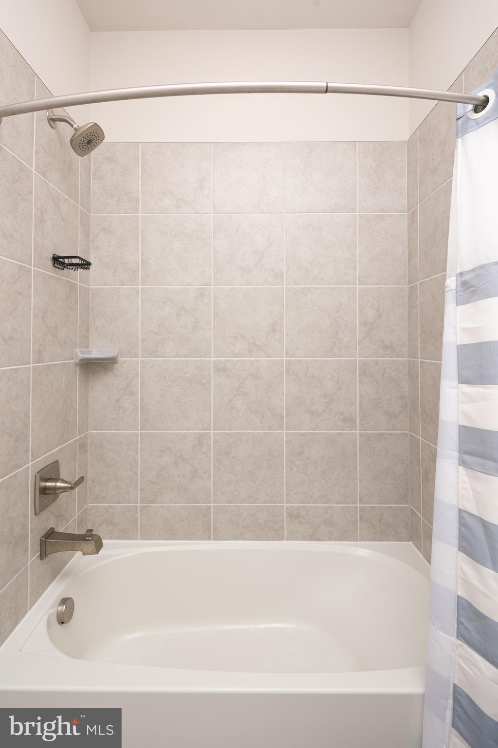 1920 Four Roses Street Baltimore, MD 21222 - Photo 28 of 37 a bathroom with a shower and a bath tub