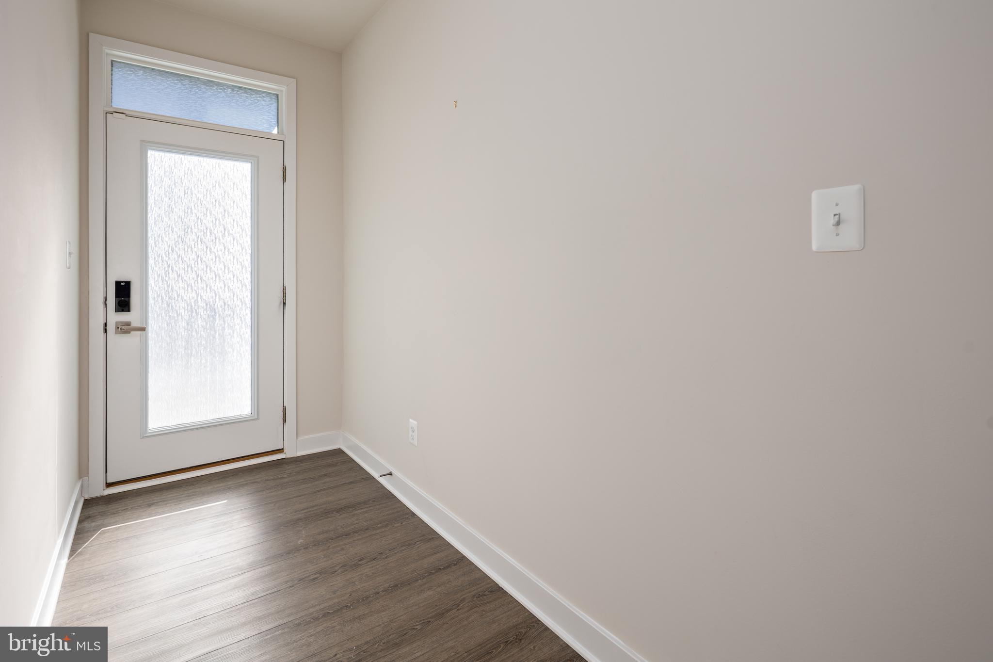 1920 Four Roses Street Baltimore, MD 21222 - Photo 34 of 37 a view of an empty room with wooden floor and a window