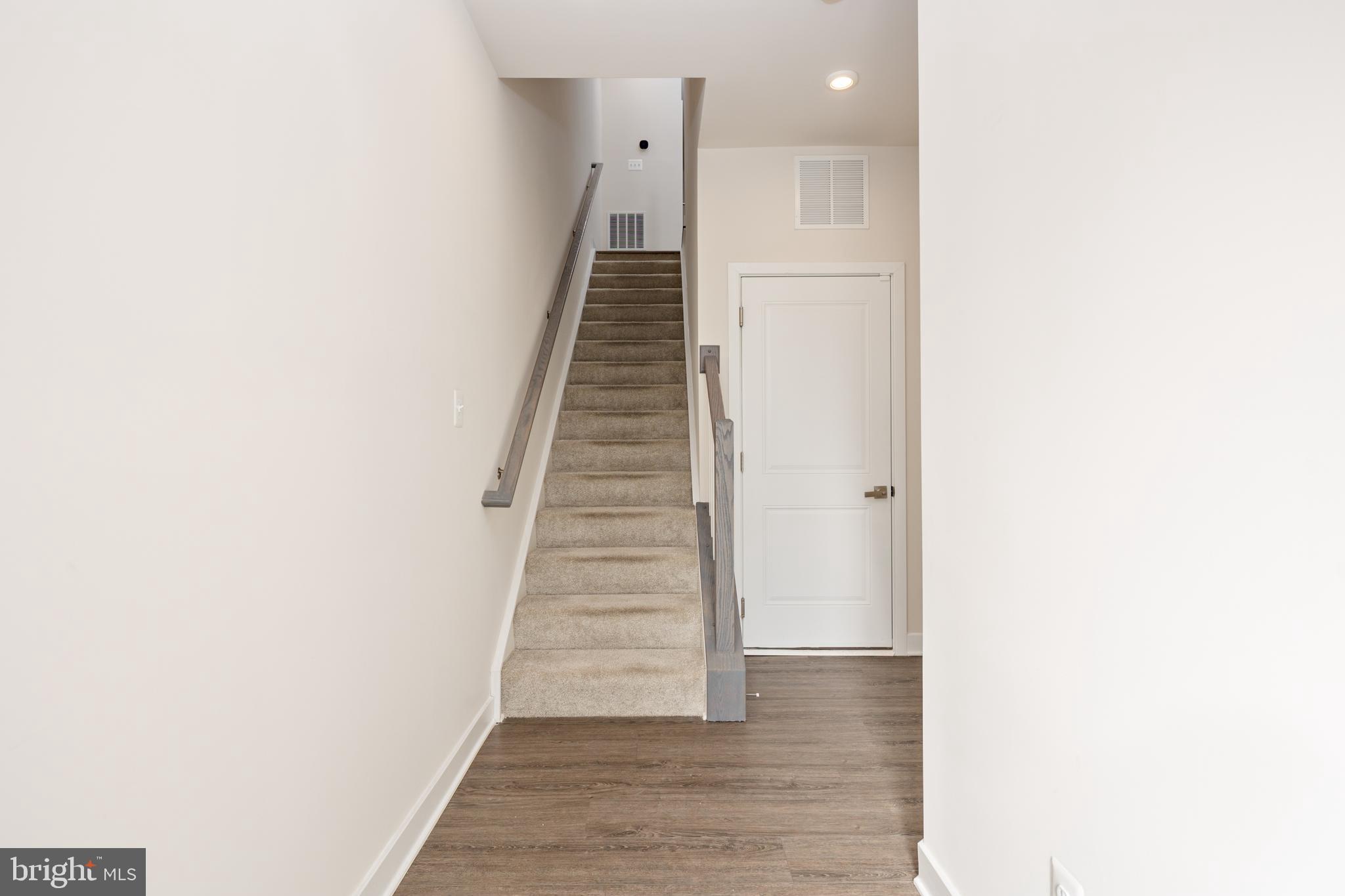 1920 Four Roses Street Baltimore, MD 21222 - Photo 35 of 37 a view of a hallway with wooden floor and staircase