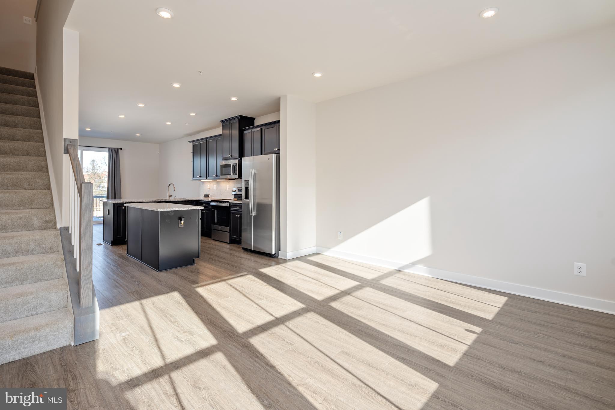 1920 Four Roses Street Baltimore, MD 21222 - Photo 5 of 37 a kitchen with refrigerator and chairs