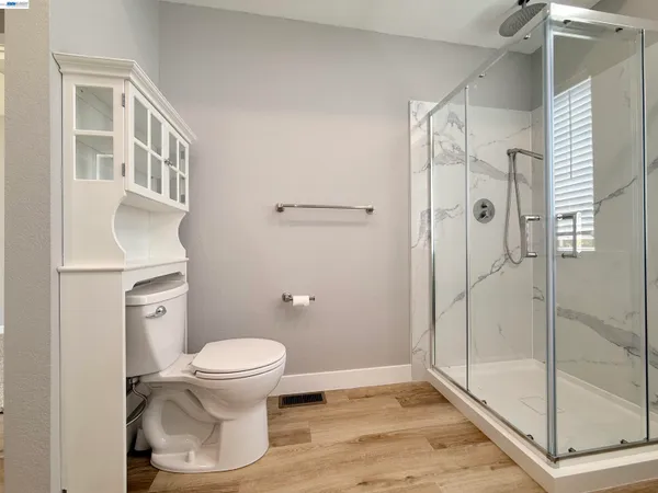 a bathroom with a toilet and a shower