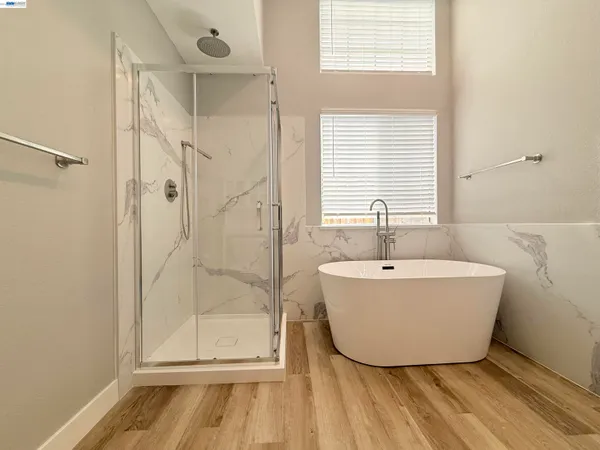 a bathroom with a bathtub and shower