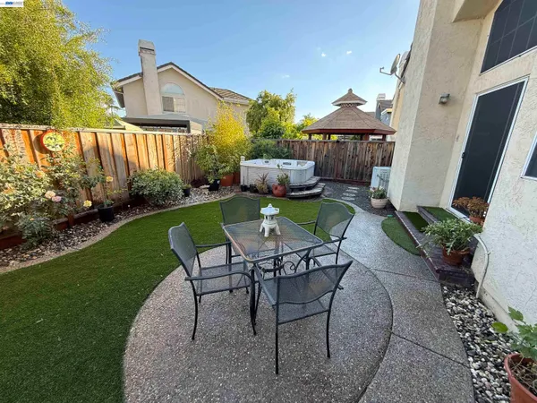 a view of a backyard with sitting area