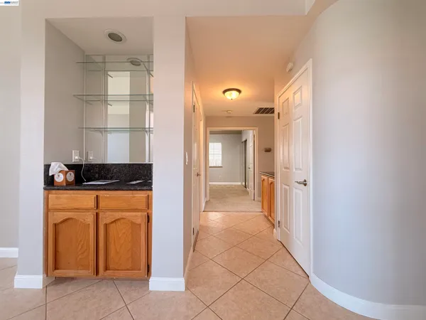 a view of a hallway with wooden floor and a cabinet