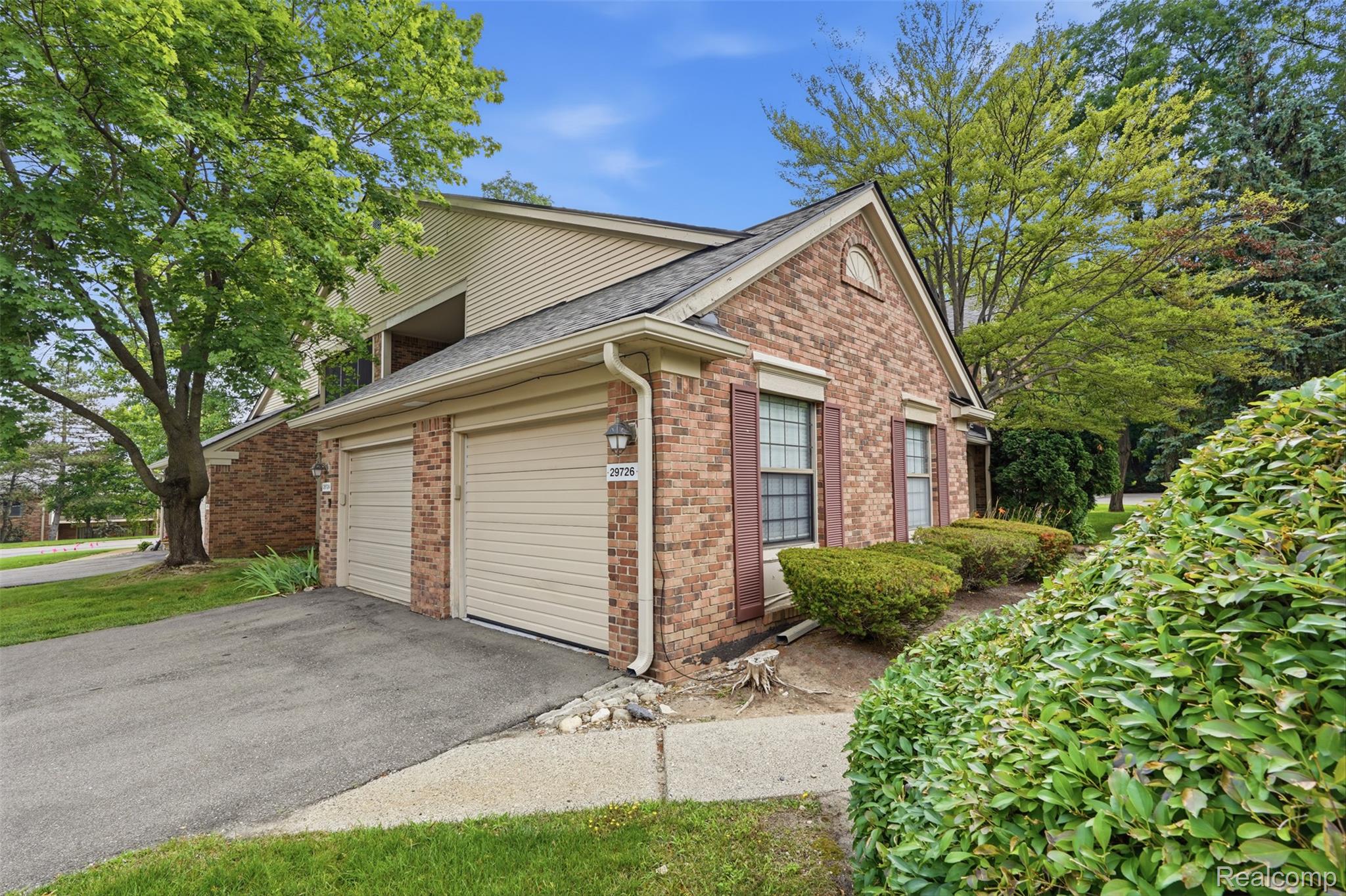 29726 Pine Ridge Circle Farmington, MI 48331 - Photo 25 of 40 Brick and siding exterior featuring an attached garage