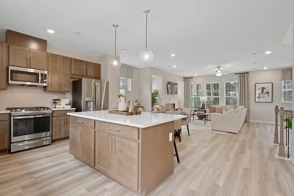 104 Epperly Way Tucker, GA 30084 - Photo 12 of 42 a large kitchen with stainless steel appliances kitchen island a large counter space a sink and appliances