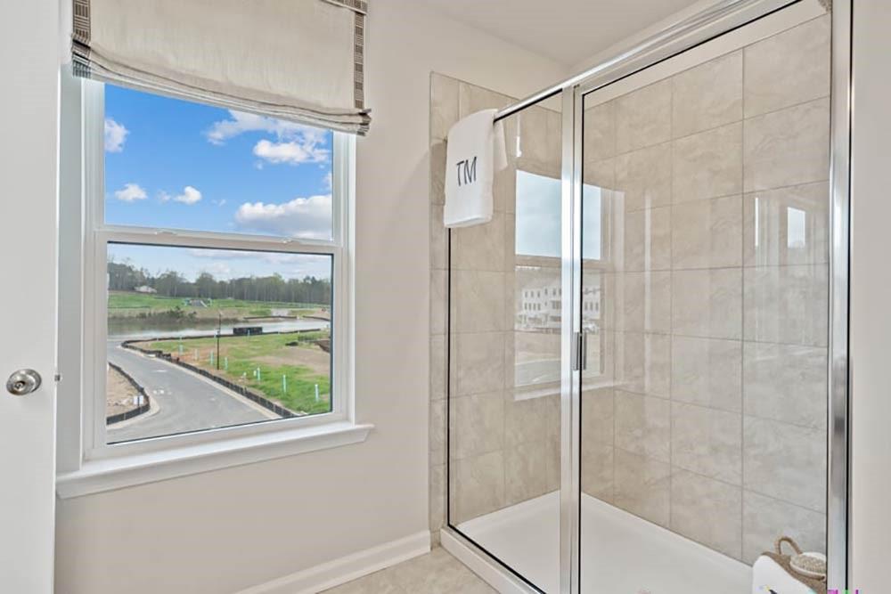 104 Epperly Way Tucker, GA 30084 - Photo 29 of 42 a bathroom with a glass shower door and a window