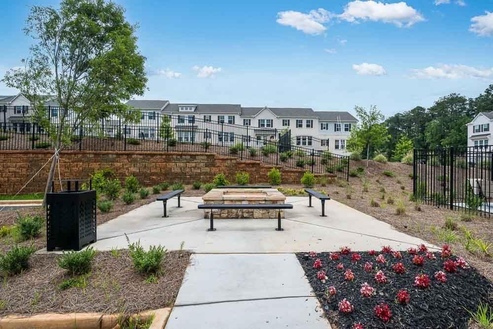 104 Epperly Way Tucker, GA 30084 - Photo 41 of 42 a view of a patio with couches table and chairs and potted plants