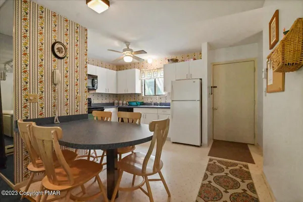 a kitchen with a refrigerator sink and cabinets
