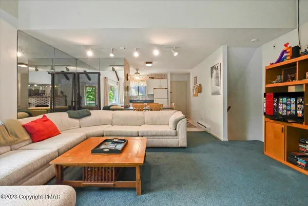 a kitchen with stainless steel appliances granite countertop a refrigerator a sink a stove and a refrigerator