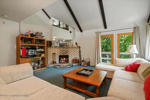 a living room with furniture a rug and a large window