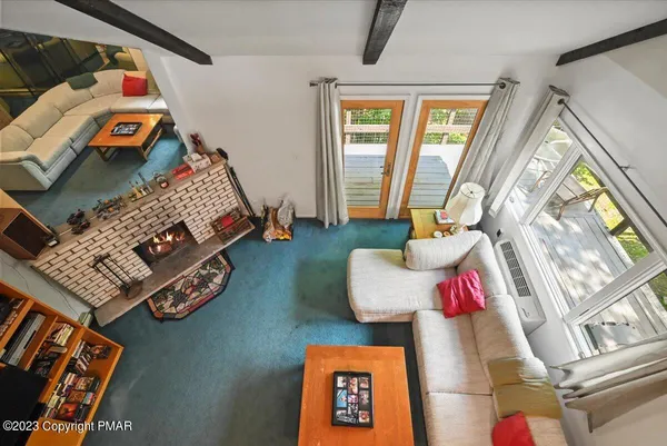 a living room with furniture a rug and a fireplace