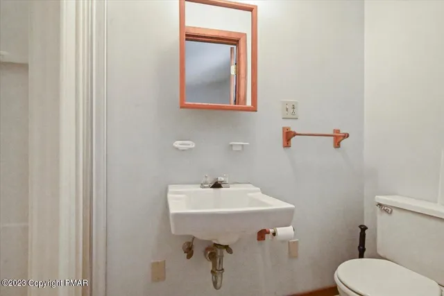 a bedroom with a bed and painting on the wall