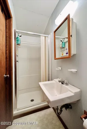 a bathroom with a sink mirror and toilet