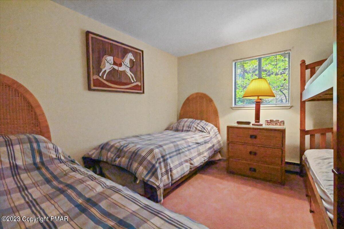 18 Middle Village Way Tannersville, PA 18372 - Photo 20 of 29 a bedroom with a bed and a lamp on dresser