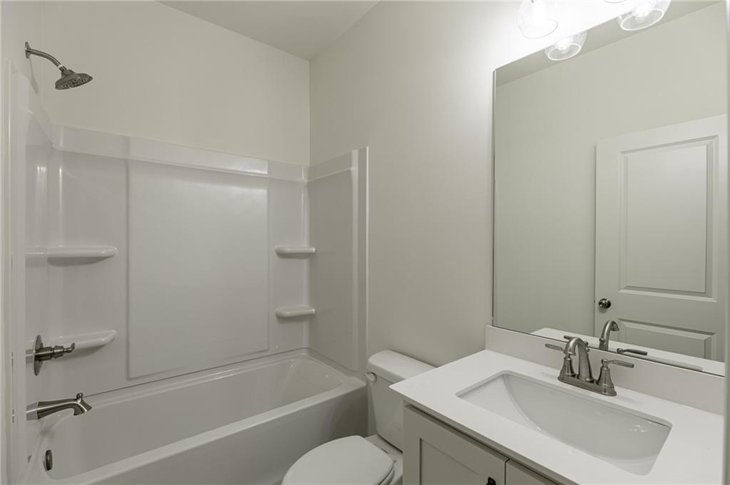 1210 Austin Road Winder, GA 30680 - Photo 31 of 56 a bathroom with a sink toilet and shower