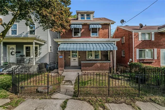 front view of a house with a garden