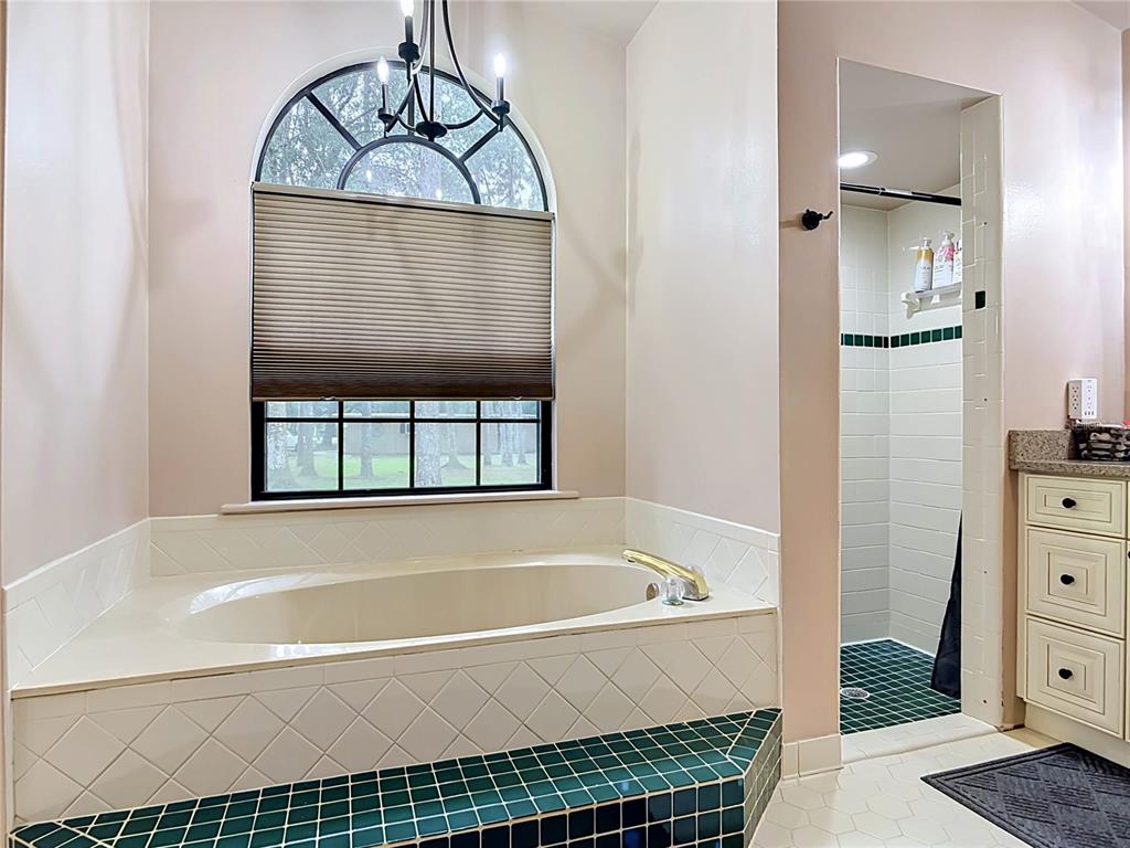 1395 Maytown Road Osteen, FL 32764 - Photo 38 of 65 a bathroom with a bathtub and a shower