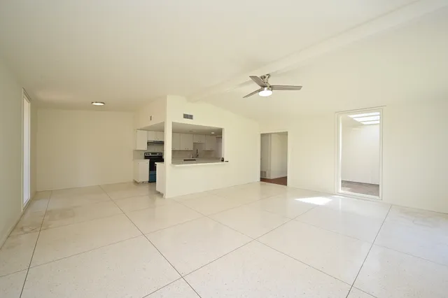 an empty room with a empty space and a ceiling fan