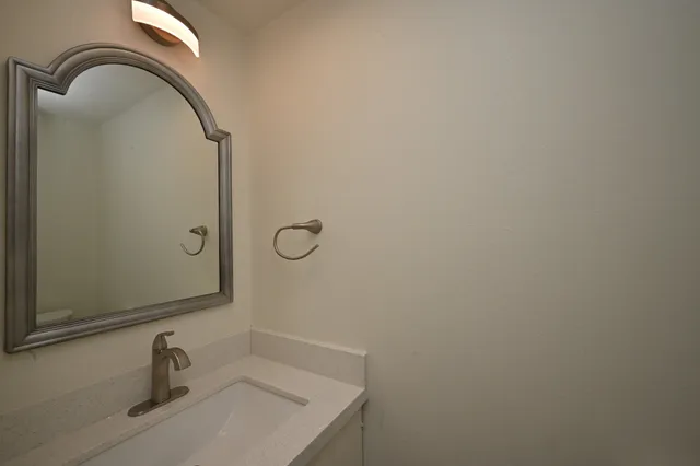 a bathroom with a sink and mirror