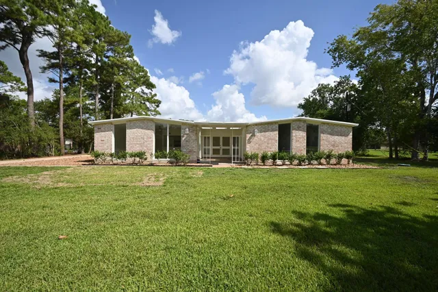 a front view of house with yard and green space