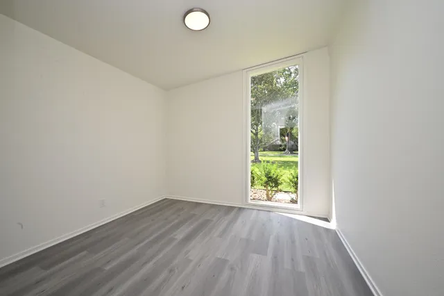 a view of room with window and hardwood floor