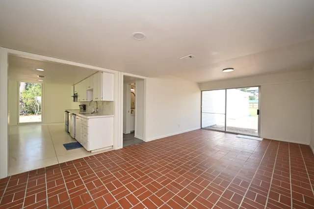 a view of a kitchen with furniture and wooden floor