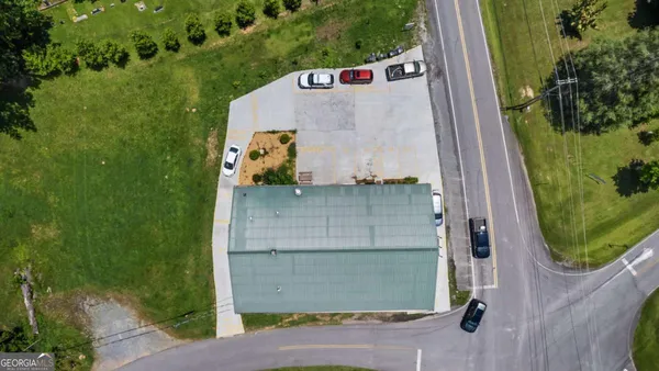 an aerial view of a house with a yard