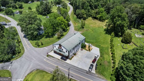 an aerial view of a house with yard swimming pool and outdoor seating