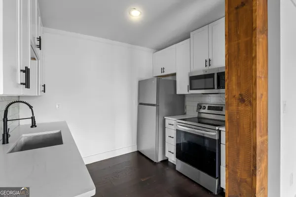 a kitchen with a sink stove and refrigerator