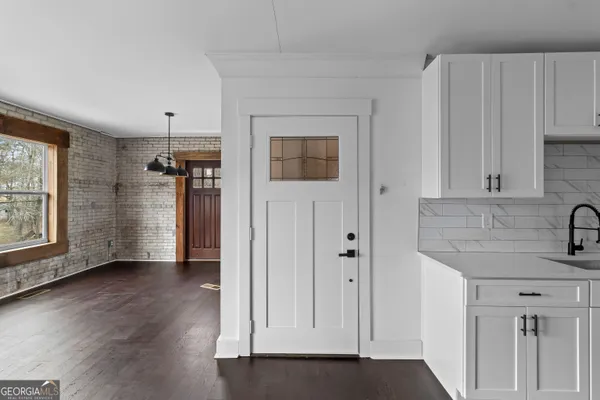 a view of a kitchen with a sink and a window