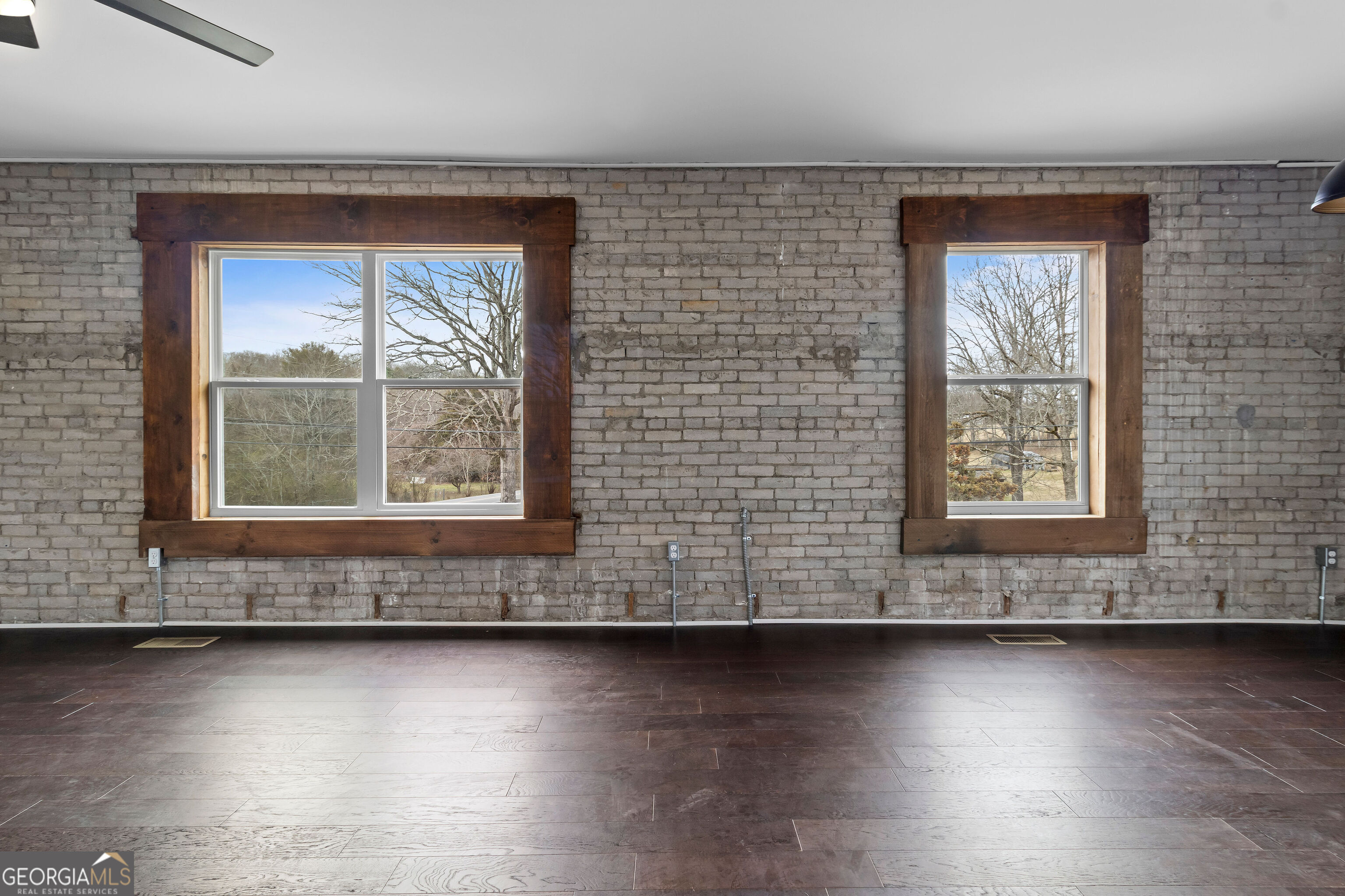 610 Madola Road, Unit 4 Epworth, GA 30541 - Photo 7 of 16 an empty room with wooden floor and windows