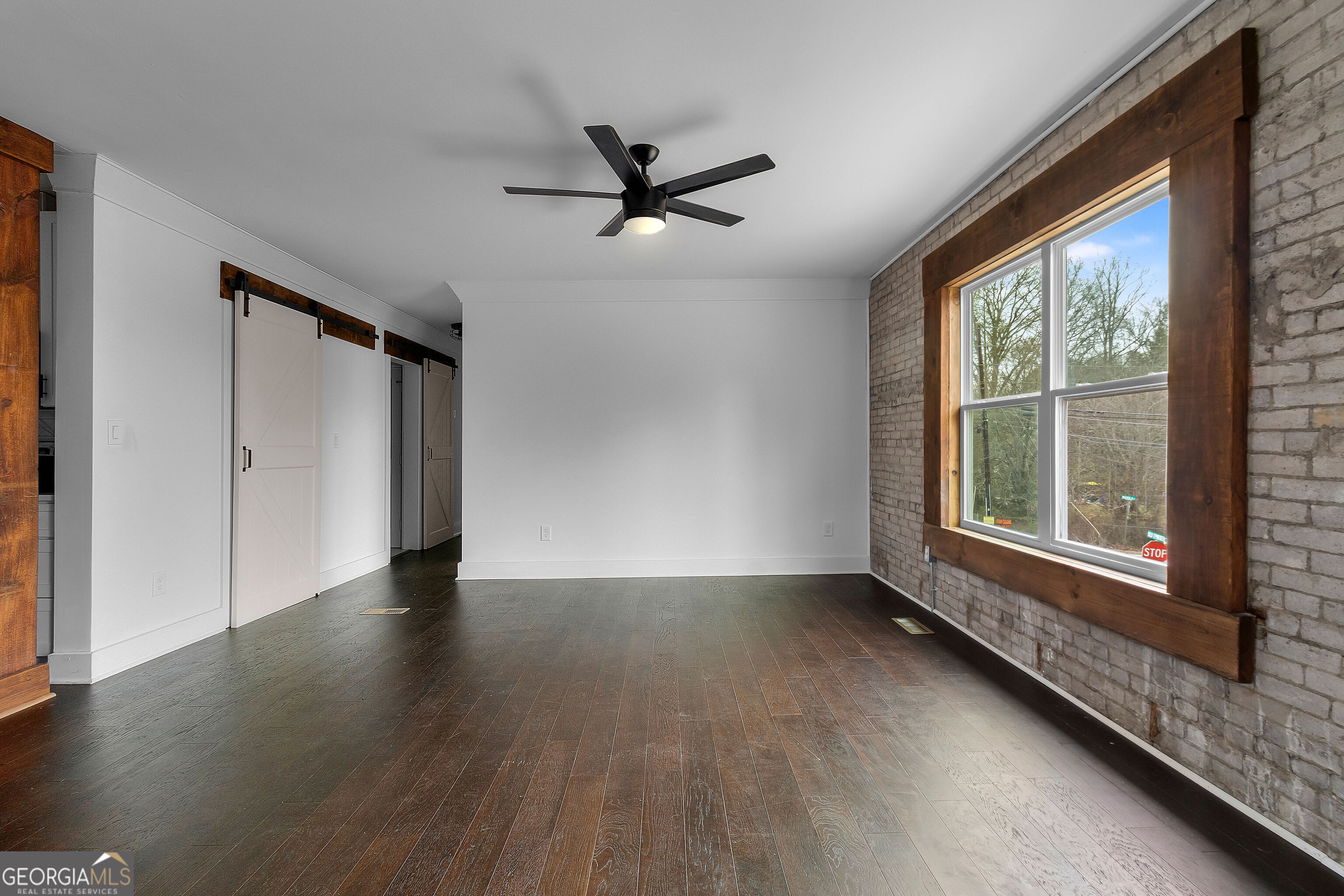 610 Madola Road, Unit 4 Epworth, GA 30541 - Photo 8 of 16 a view of an empty room with a window and wooden floor
