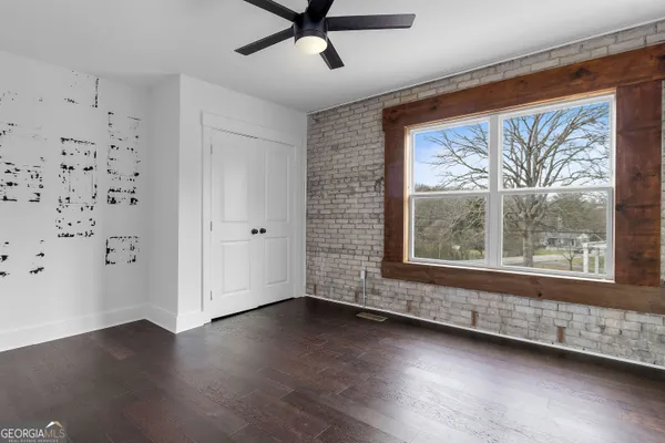 a view of a livingroom with wooden floor and a window