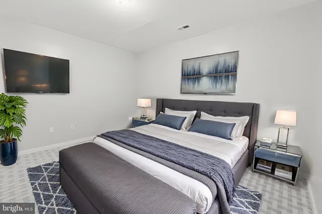 a bedroom with a bed and a flat screen tv