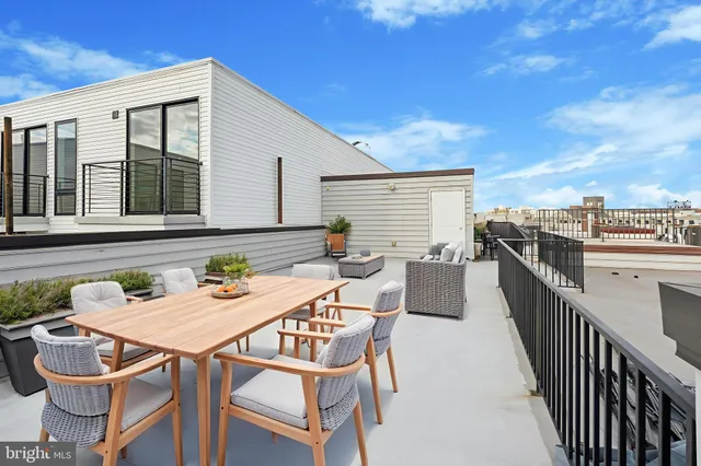 a view of a dinning tables and chairs in the balcony