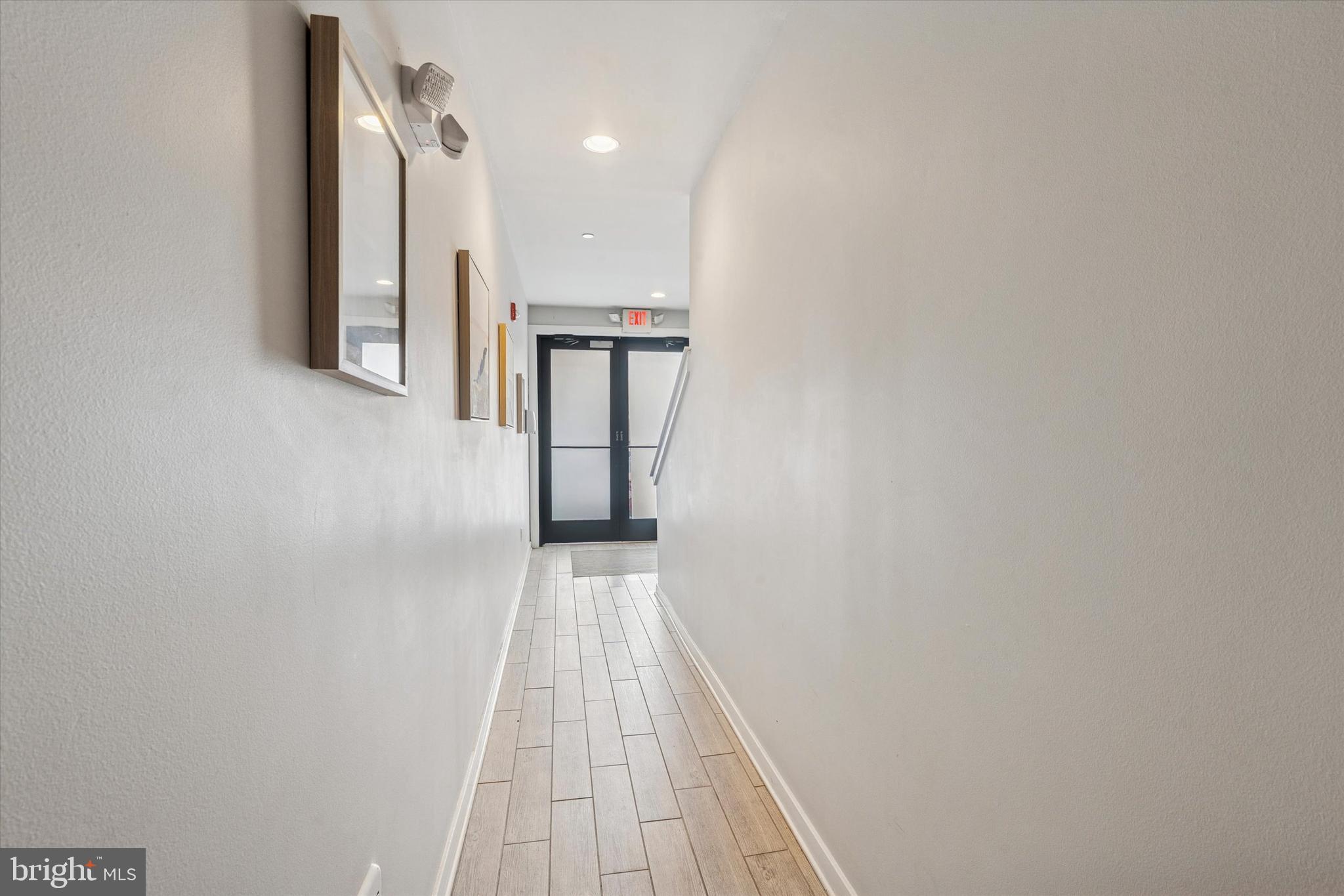 1608 Ridge Avenue, Unit 403 Philadelphia, PA 19130 - Photo 4 of 18 a view of a hallway with wooden floor and staircase