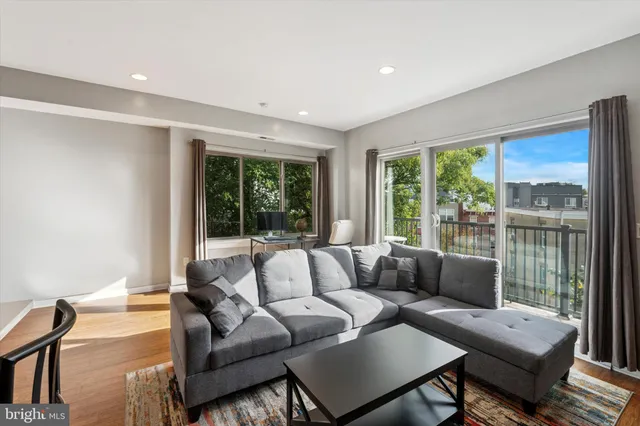 a living room with furniture and a large window