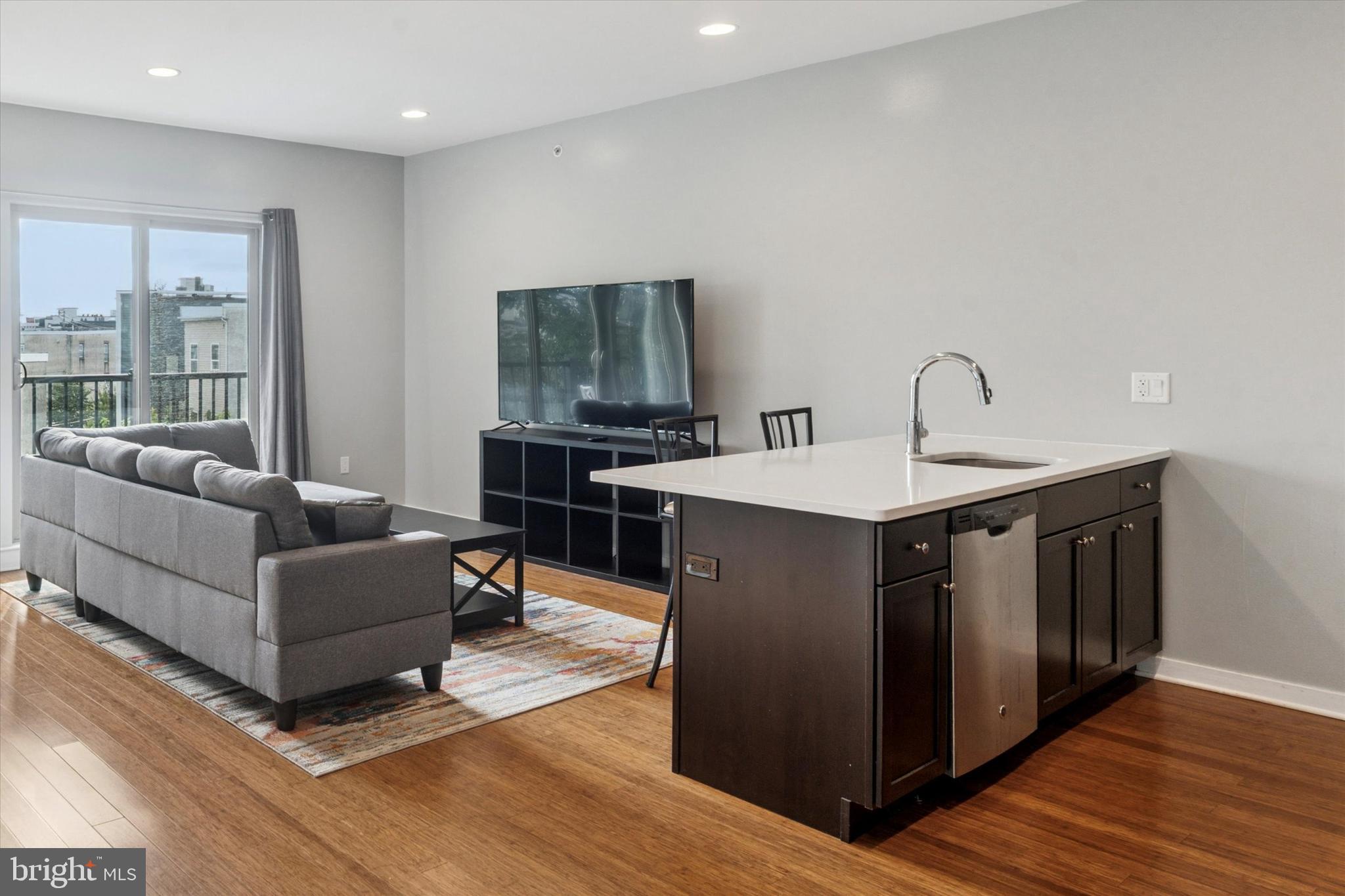 1608 Ridge Avenue, Unit 403 Philadelphia, PA 19130 - Photo 8 of 18 a living room with furniture and a flat screen tv