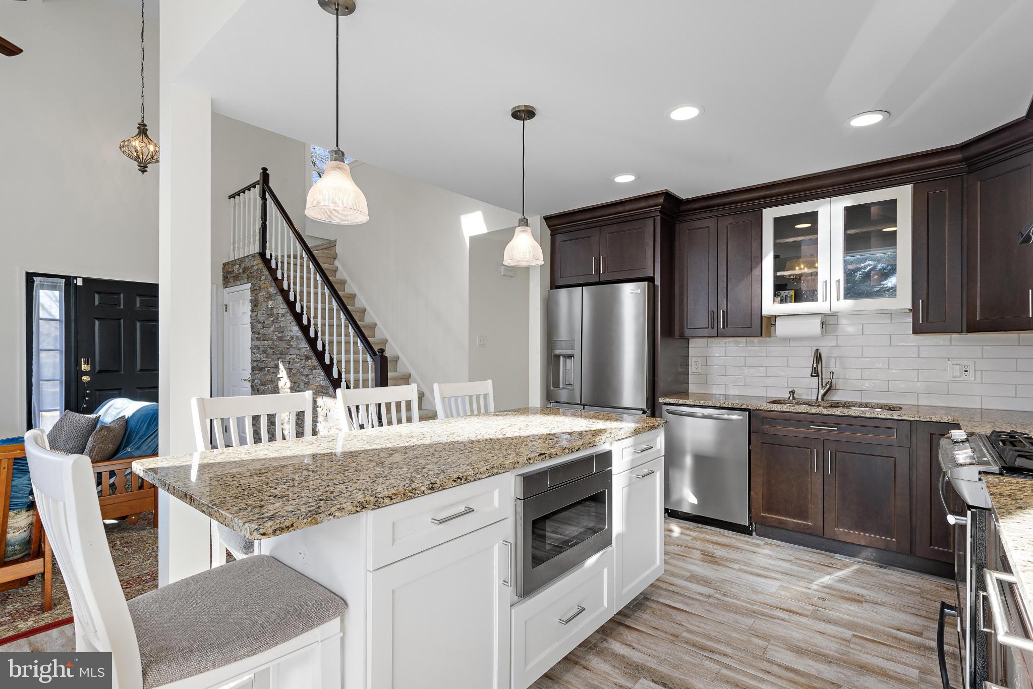 1 Hilltop Lane Medford, NJ 08055 - Photo 10 of 50 a kitchen that has a stove a sink a microwave a dining table and chairs