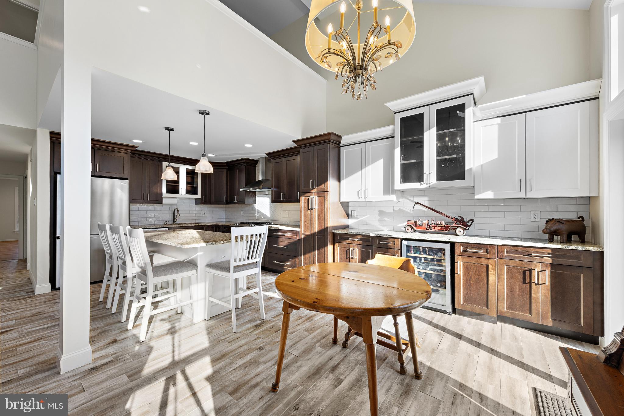 1 Hilltop Lane Medford, NJ 08055 - Photo 19 of 50 a kitchen with stainless steel appliances granite countertop a table chairs stove and cabinets
