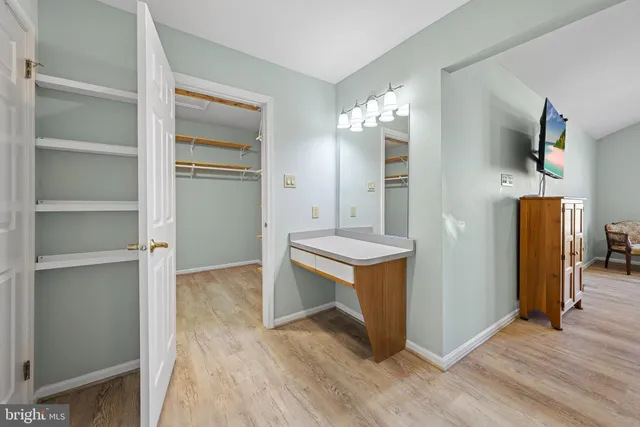 a view of kitchen with stainless steel appliances cabinets and wooden floor