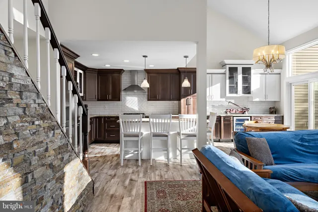 a living room with furniture a fireplace and a chandelier