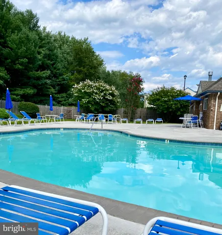 a view of swimming pool with a garden and trees